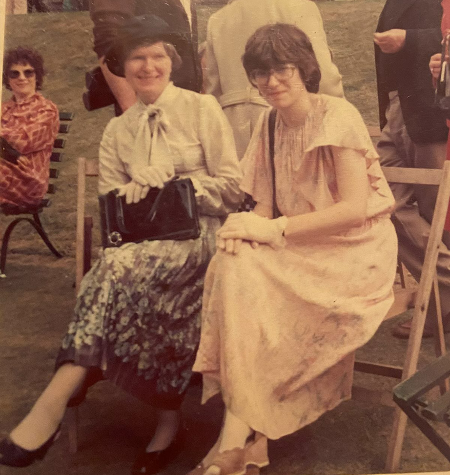 mother and daughter seated in formal dresses