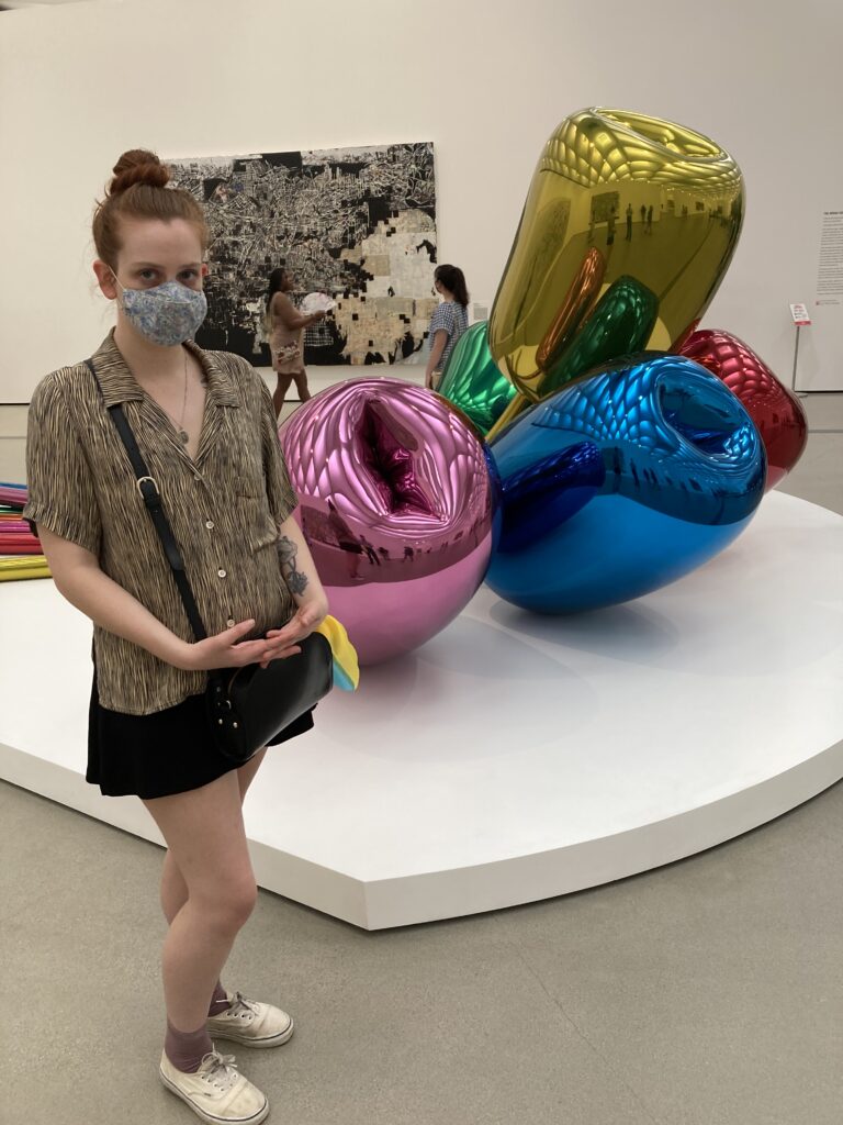 woman in front of a sculpture