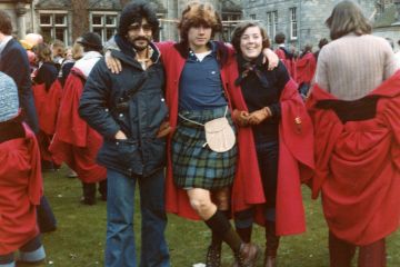 Thomas (centre) poses for a photo with two friends during Raisin Weekend at St Andrews