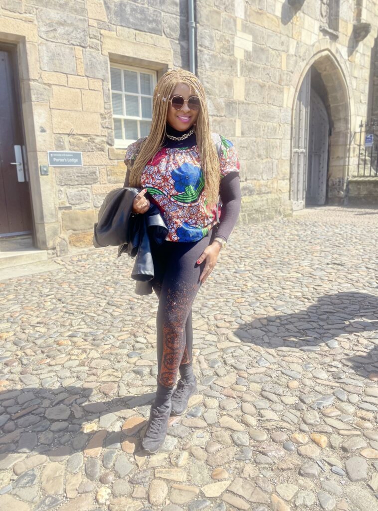 Racheal poses for a photo outside of St Salvator's quad, she is standing on the cobbles outside the main arched entrance