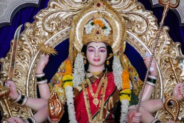 The Mother Goddess Durga, shown with multiple arms and a golden headdress.
