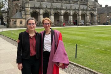 Silvia (right) and her daughter Anita (Left) pose for a photo in St Salvator's Quad. Silvia wears her St Andrews gown.