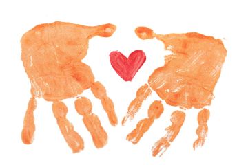 The image shows two orange paint stamped hands around a red painted heart