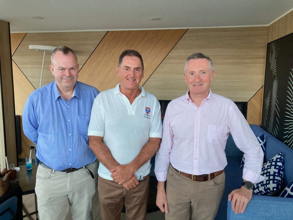 Three alumni pose for a group photo