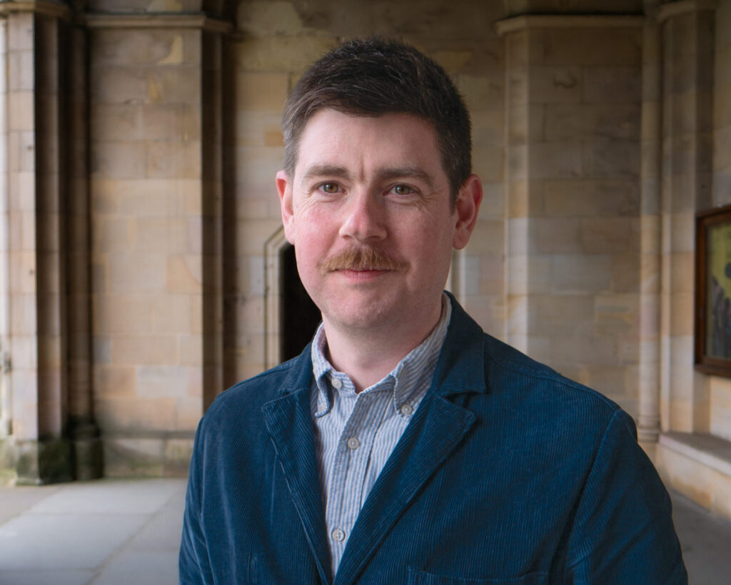 Headshot of Dr Niall Sreenan in the cloisters, St Salvator's Quad