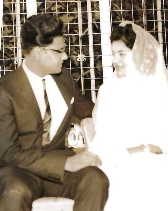 A black and white wedding photograph from 1962, showing the bride and groom seated together.